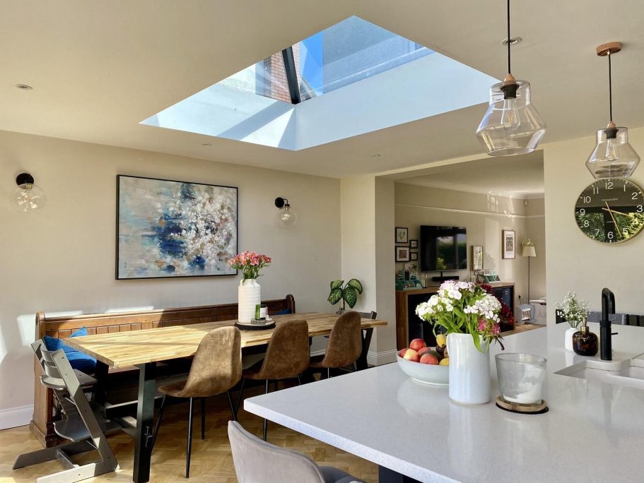 Modern kitchen extension with bi-fold doors leading to a garden in Surrey